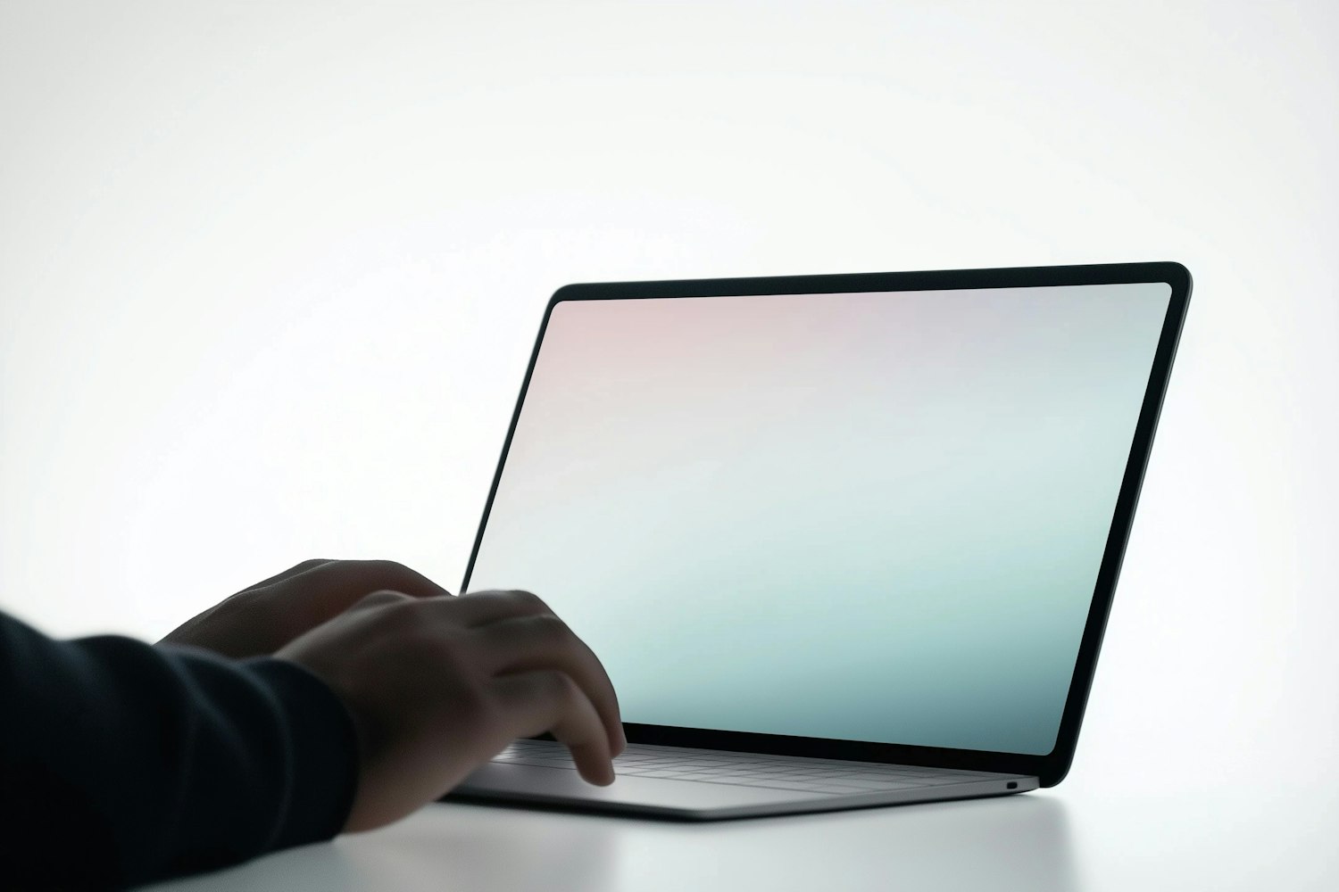 Hands typing on a laptop with a colourful screen