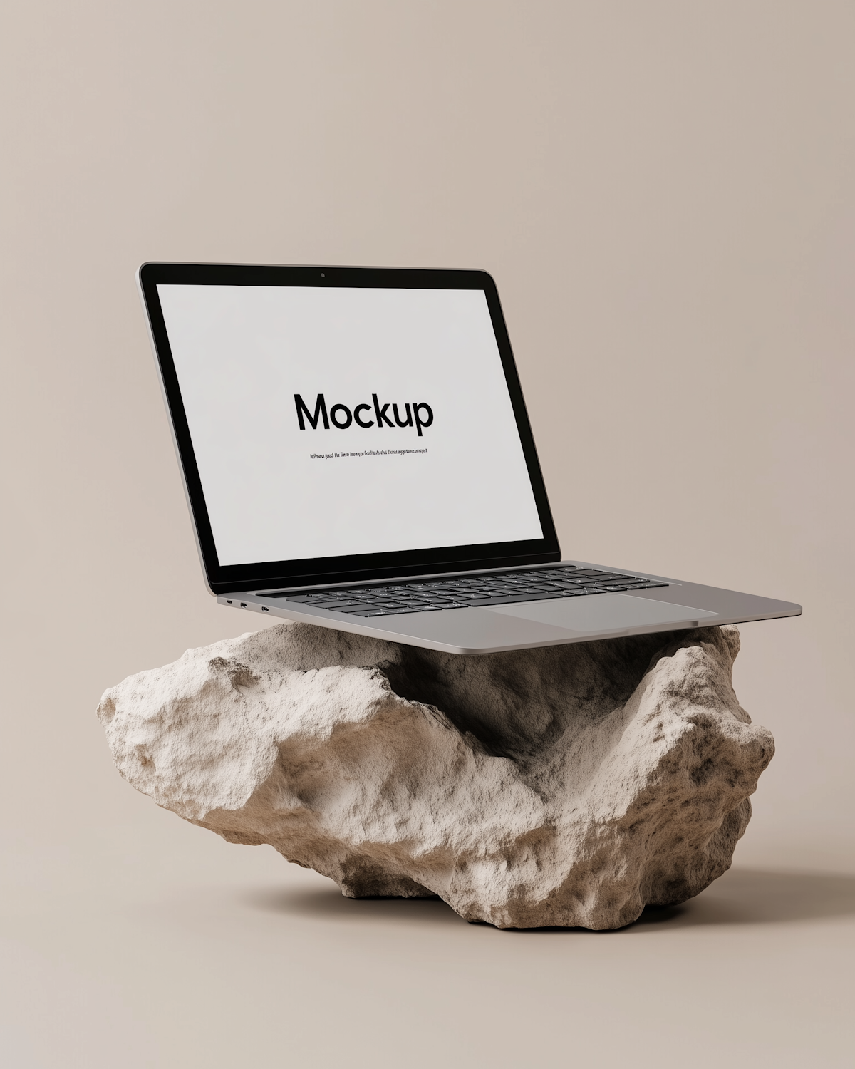 Laptop showing a website design, resting on a rock